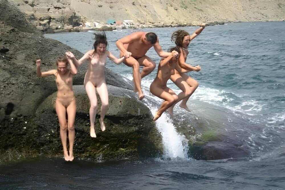 Mens and girls nudists on a beach - Nudism and naturism are a philosophy of life and a culture of interaction