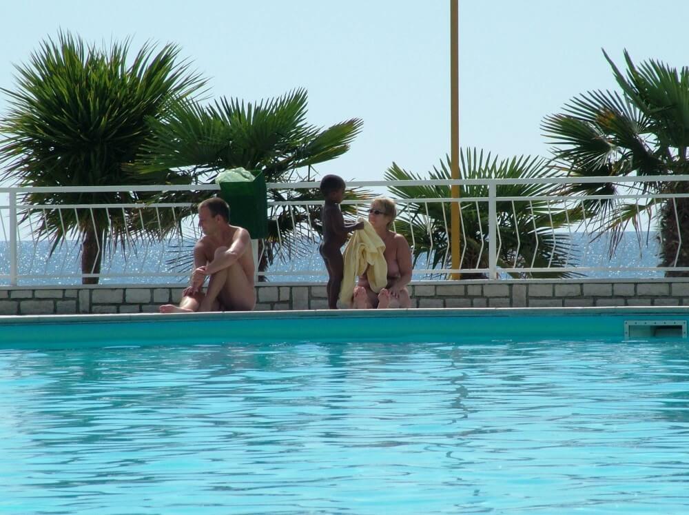 Photo of naturists in an outdoor pool - Nudity is part of natural existence